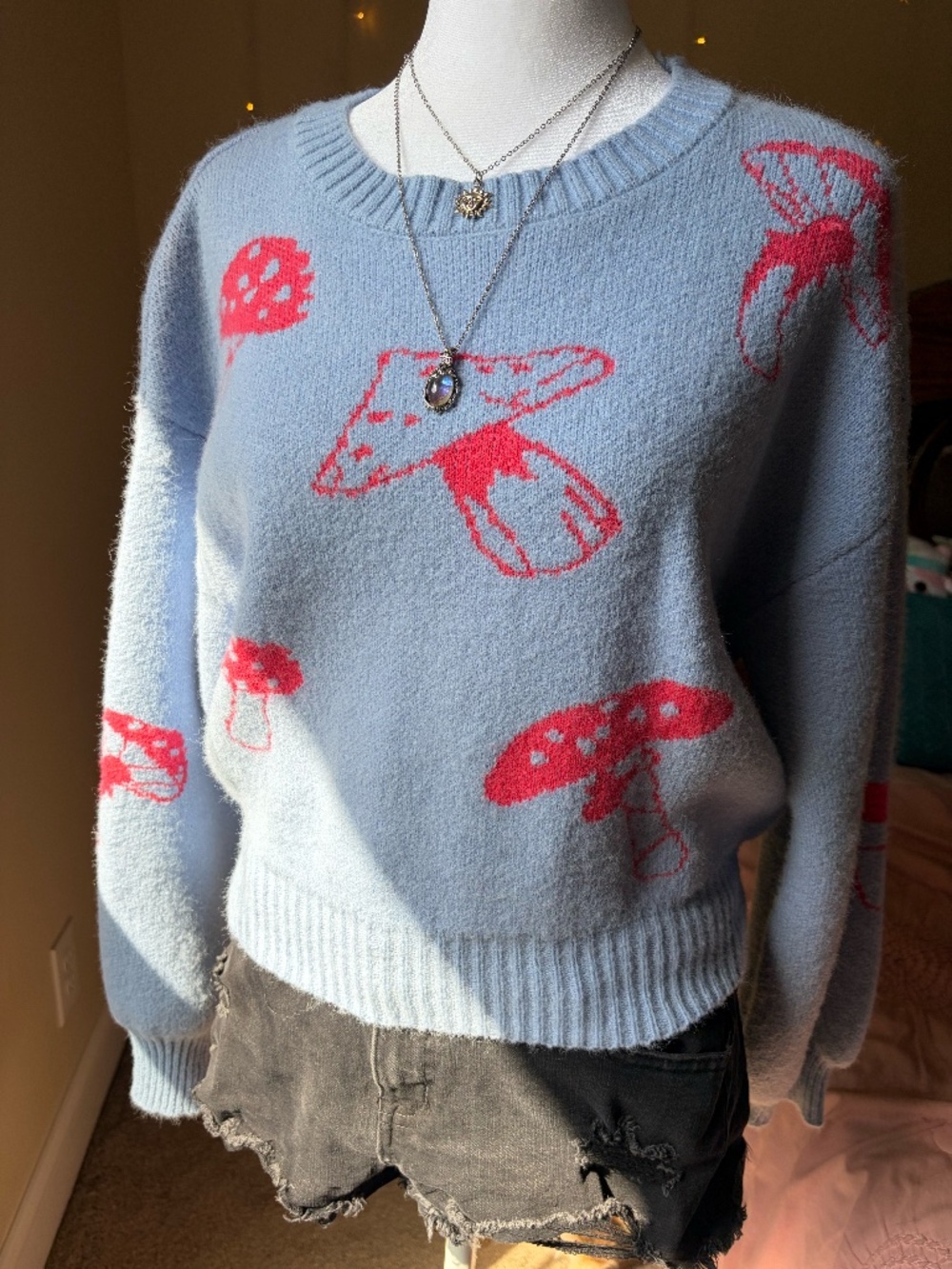light blue sweater with red mushrooms